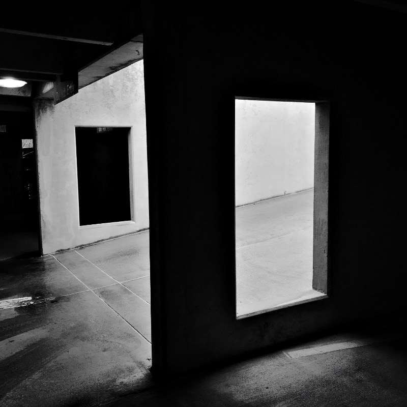 Black and white photograph of parking garage, isolating two rectangular cutouts
