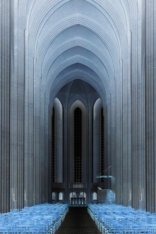 Inverted-color image of cathedral interior facing altar and pipe organ